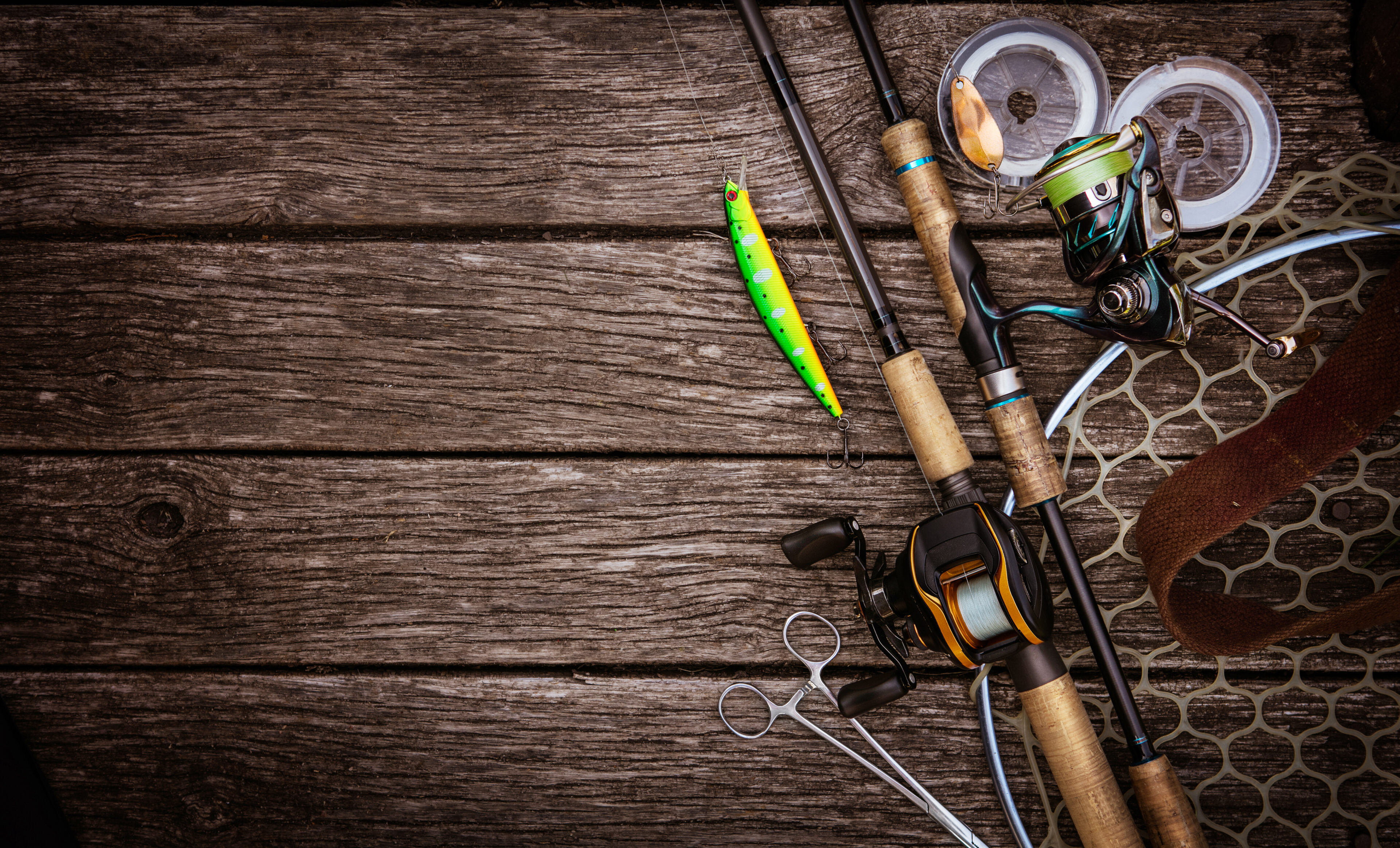 Fishing gear on wooden surface.